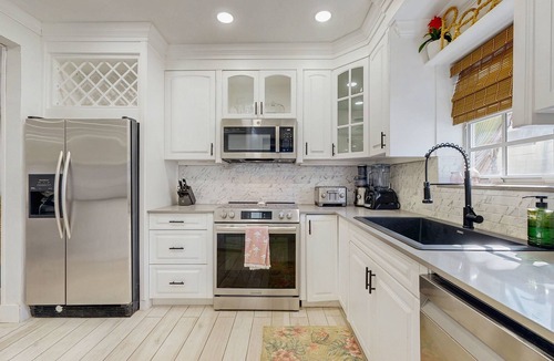 Santa Barbara Estates House | Tropical backyard oasis w/putting green, grill, tiki bar & walk to beach