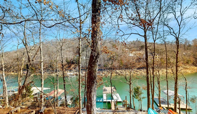 Rustic lakefront retreat with a hot tub, double-deck dock, firepit, grill & deck